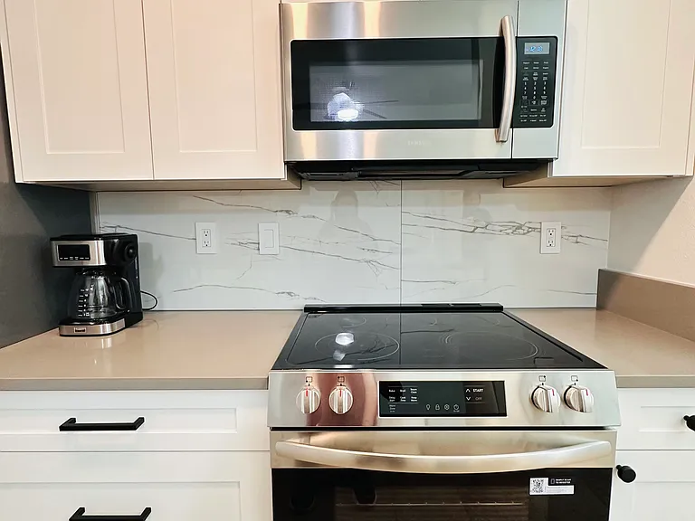 Brandnew kitchen stove and Samsung microwave.