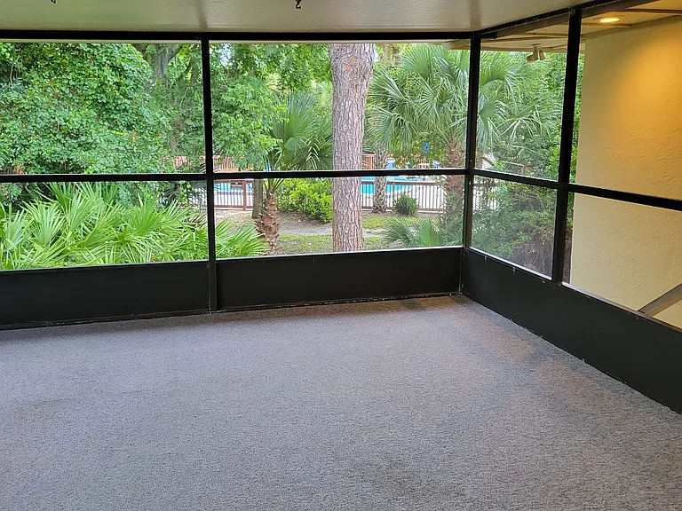 Spacious screen porch overlooking the backyard and pool.