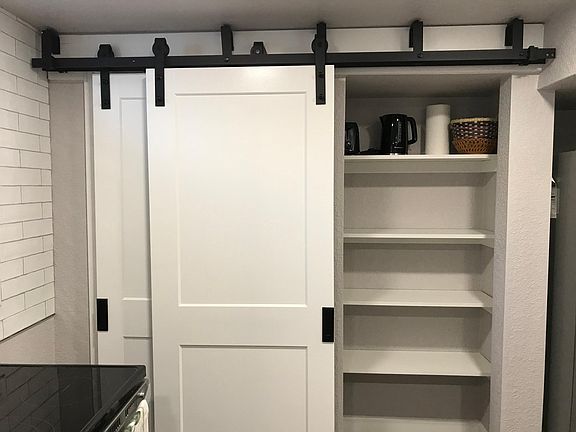 The barn door opens up to a large pantry for all your favorite foods!