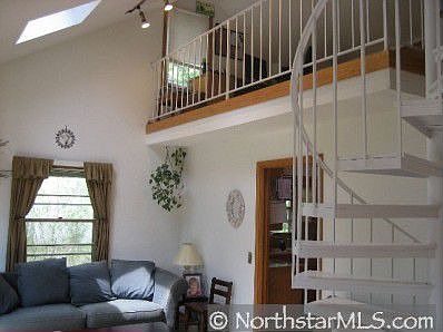Vaulted LR with spiral stairs, hw floors, skylights and huge bay windows!