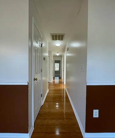 Hallway houses a coat closet and a linen closet.