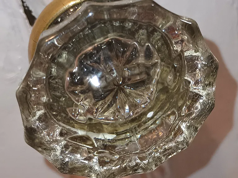 This is a photo of one of the original Glass Door Knobs on this 1940's Vintage home. It belongs to the house. It is what makes the house special. Please put it back.
