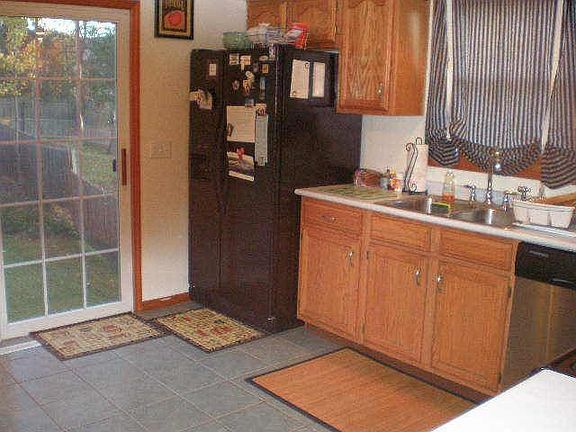 Kitchen w/ sliding glass door & deck. Brand new Fridge as well.