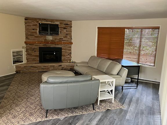 Living room area with gas fireplace and TV mounts above.