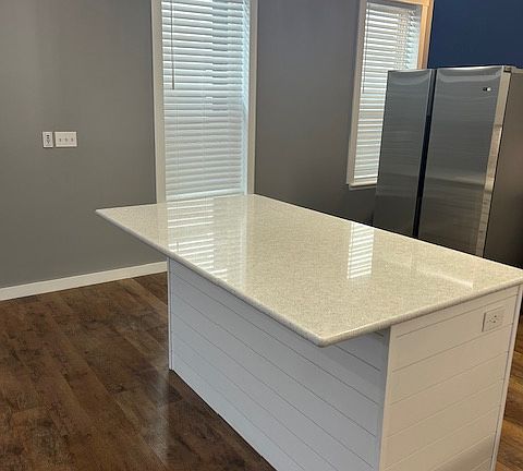 Island with New Quartz Counter top. Room for 4-5 Stools.