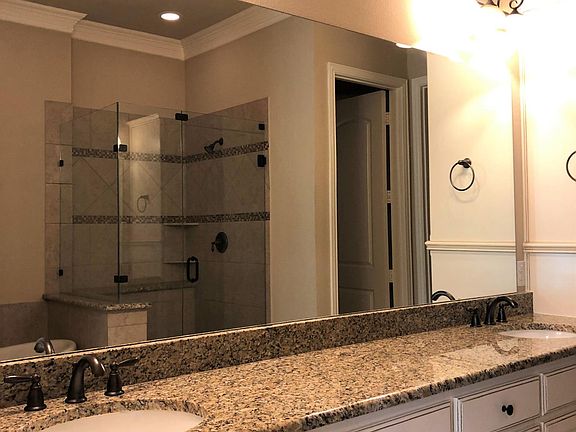 Master bath with separate tub and shower. Enclosed toilet area. Walk in closet with built-in shelving.
