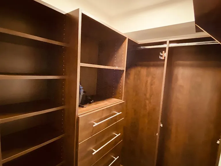 Large Walk In Closet with Tons of Storage! Iron and Ironing board included