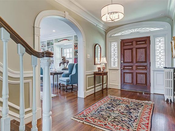 This gorgeous entry with the original door, wood floors and new chandelier make an impressive statement.
