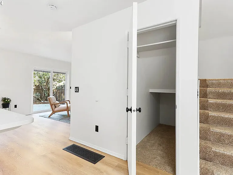 Pantry and stairs from the kitchen leading up to all bedrooms (photo taken before the living room was painted)