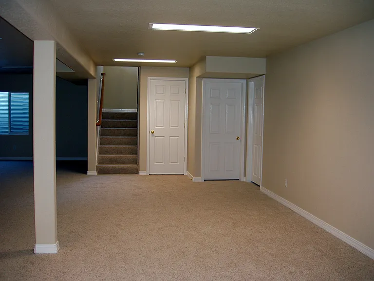 Lower Level - stairs to main level
Storage room under stairs and
Additional Storage Room on right. Third door is more storage room.