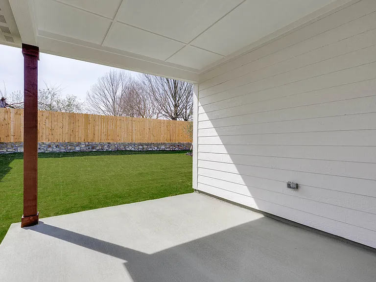 The covered back patio provides a wonderful space for outdoor living.
