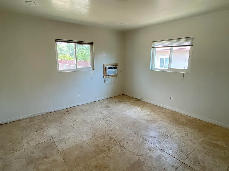 bedroom with travertine stone flooring