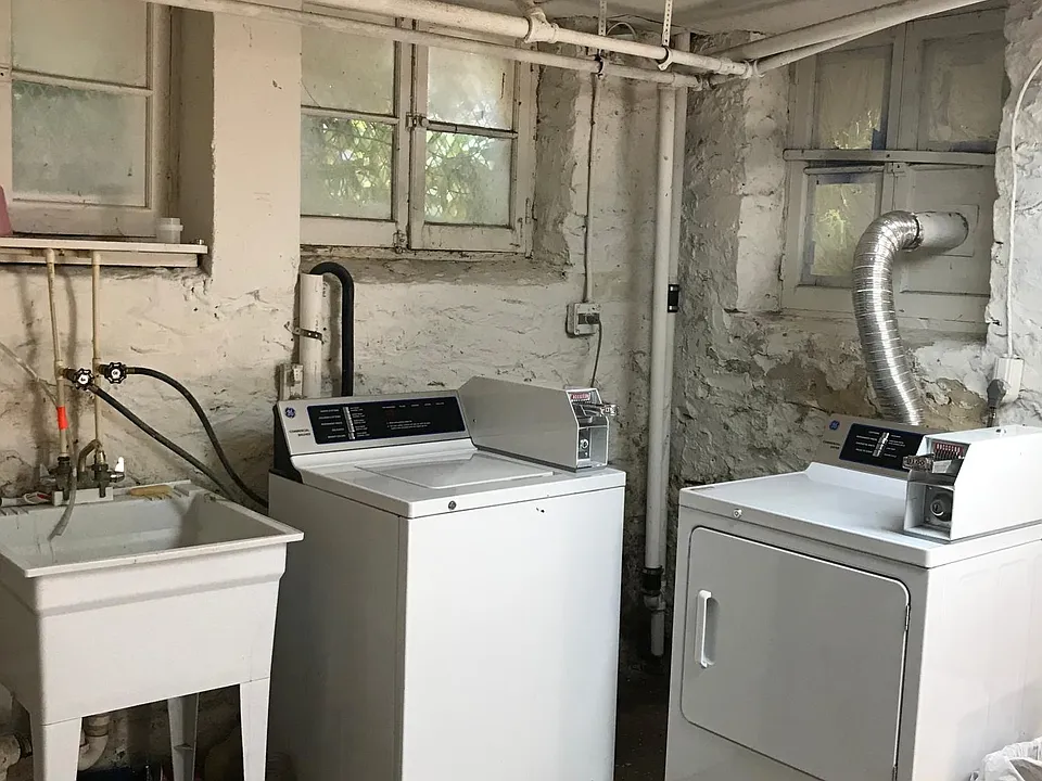 Laundry room with updated appliances in basement
