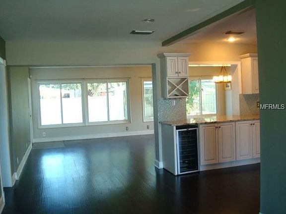 From entry way looking through to family room and dining area. Living room to the extreme right opening to kitchen