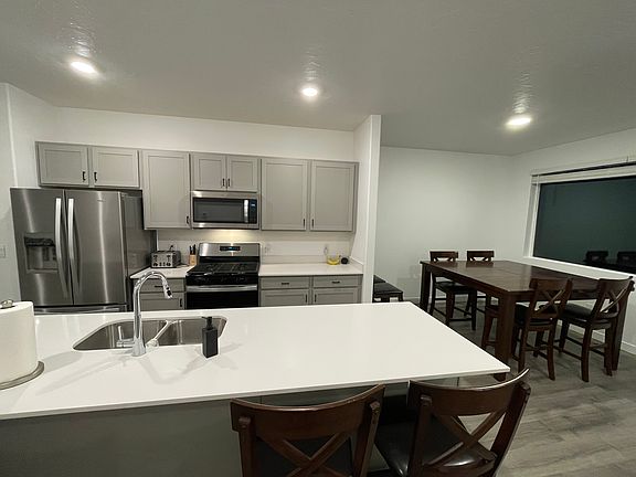 Brand new kitchen with stainless steel appliances and gas stove