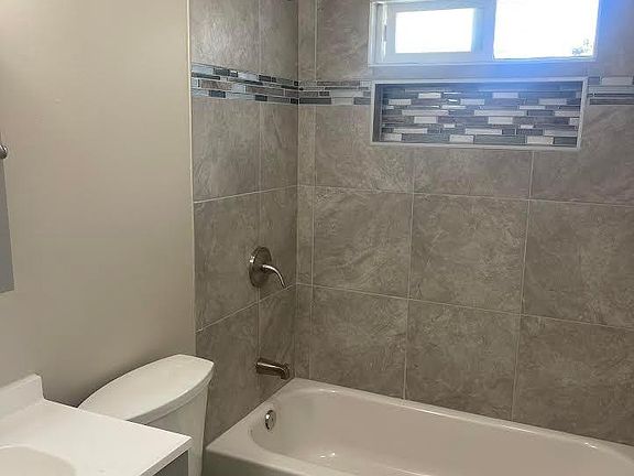 Master bathroom with new bathtub, new tile, new toilet and new sink