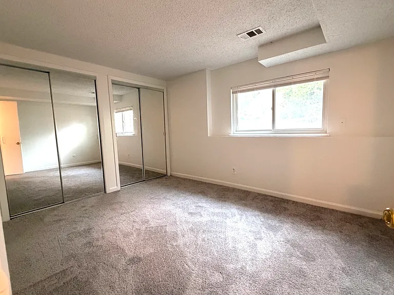 The master bedroom with 2 closet doors - brandnew carpet and paint