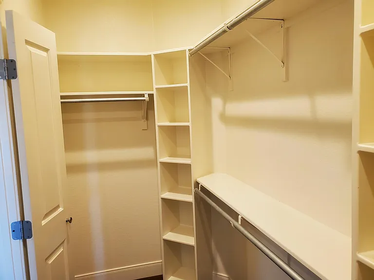 inside of walk in closet in master bedroom.