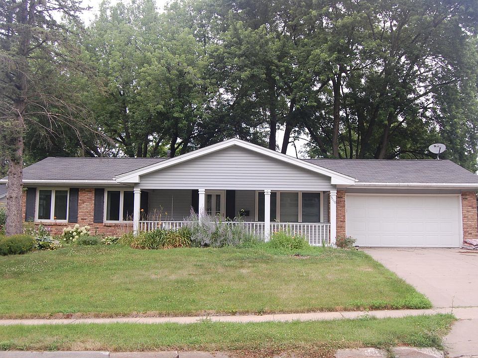 Landscaped front yard with covered porch.