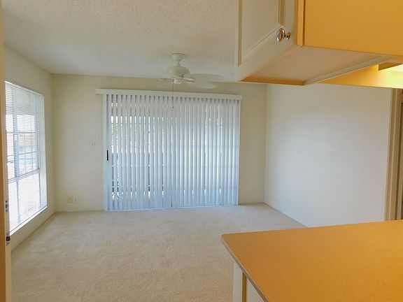 Vertical blinds over sliding doors to the covered lanai