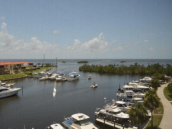 View off the lanai to the West and South. Looks at the entrance to the Marina as well as Pine Island, Cayo Costa, and Boca Grande.