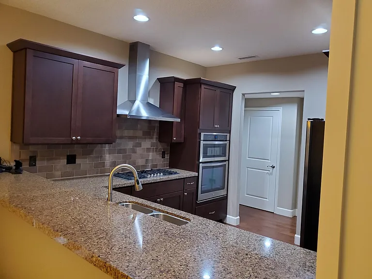 Kitchen with gas range and panty. Powder room off kitchen.