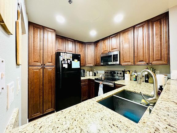 An open connect design has easy access to the kitchen from the breakfast bar height counter for a chief to serve up delicious meals.