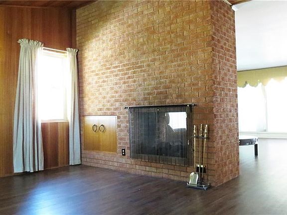Wood burning fireplace sees through into the other living space