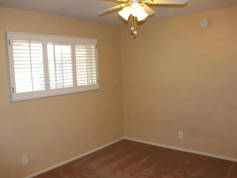 bedroom 2 - with shutters and ceiling fan