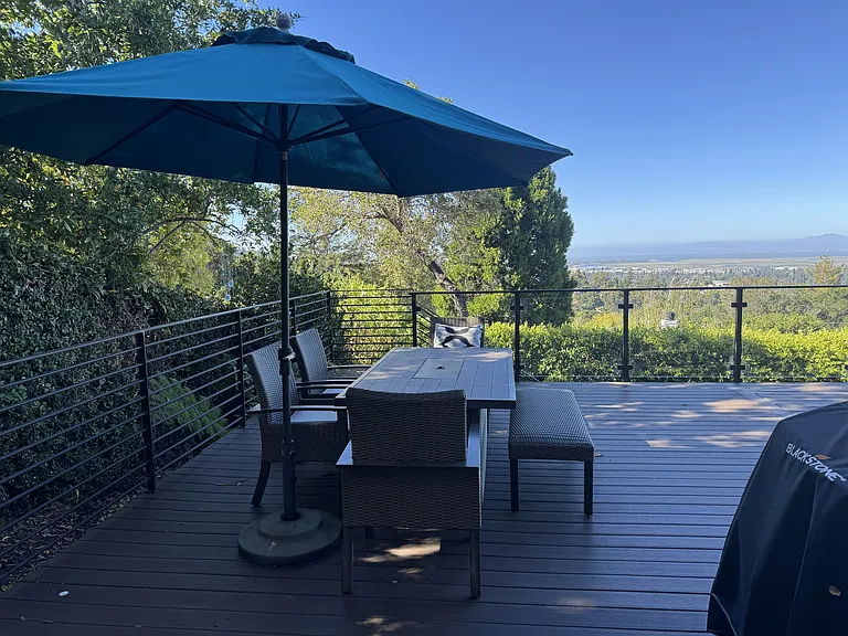 Back porch seating area with BBQ and griddle available for use.