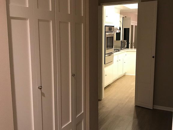 Custom hall closet off entry looking in to kitchen