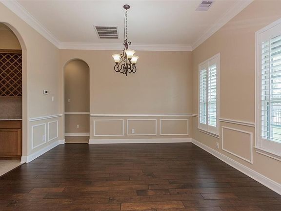 Formal Dining Room, Plantation Shutters, Upgrade Light Fixture, Wood Floors, Chair Railing, Plus Crown Molding.