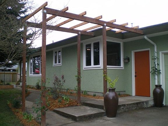 Second entrance into large "mud/utility" room. Trellis is planted with Kiwi, Hops,