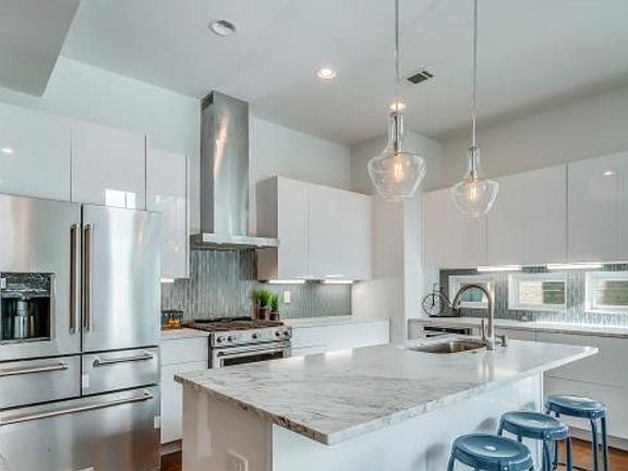 Modern white kitchen with high-end appliances