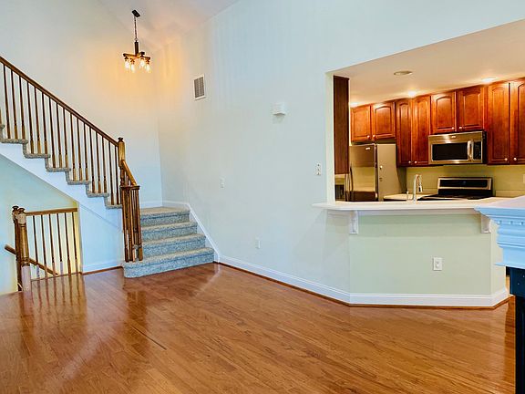 Living room and stairs up to third floor bedrooms and loft family room
