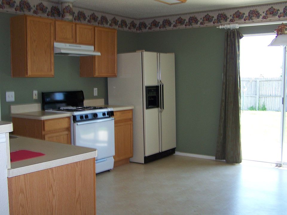 Kitchen with gas stove and refrigerator provided