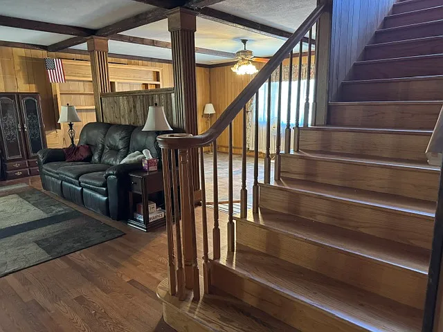 LIVING ROOM, PARLOR, AND WINDING STAIRCASE TO UPPER FLOOR.