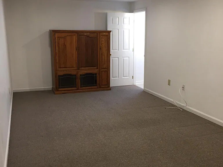 Downstairs back room with its own bathroom which has a window. Cannot call this large room a 4th bedroom because it doesn't have its own window.