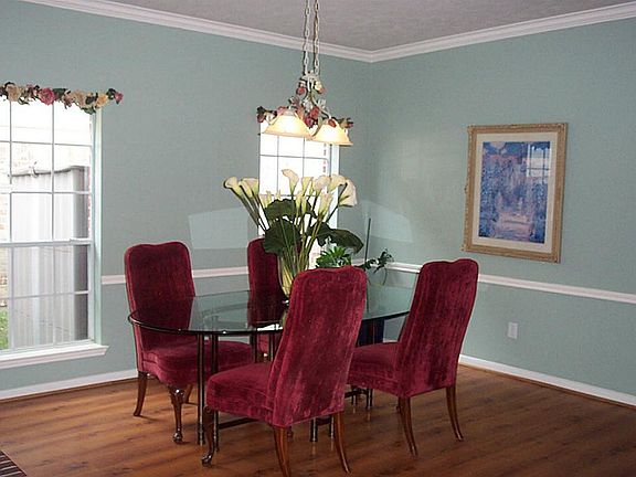 The formal dining room is adjacent to the living room, separated by a two sided fireplace.
