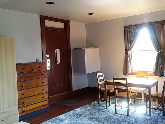 Main Room - wardrobe, dresser, entry, table (West window)