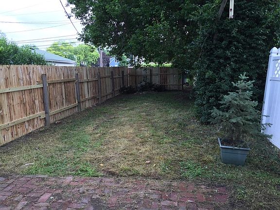 Rear yard, off street parking behind rear fence.