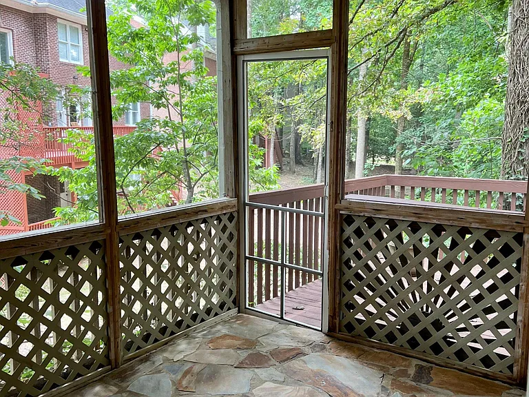 Screened in porch with access to back deck