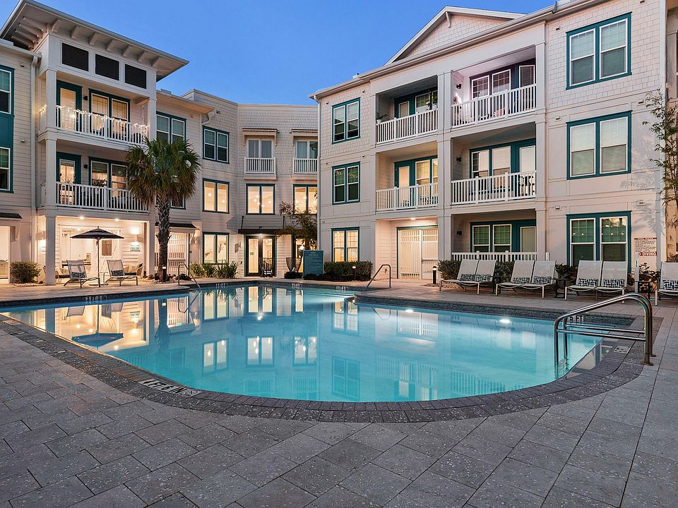 Experience luxury living with a stunning poolside view, perfect for relaxation and leisure.
