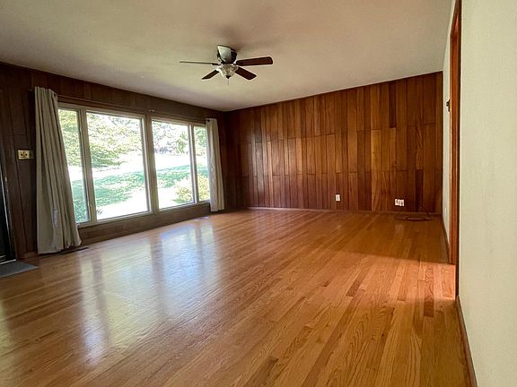 Pretty tongue and groove panelling and floor to ceiling windows looking out to front yard.