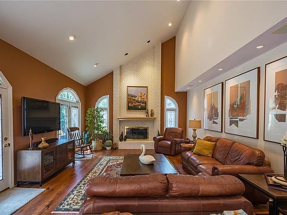 22x16 Family room with herringbone floor to ceiling brick fireplace, gorgeous windows and privacy through the double doors to th
