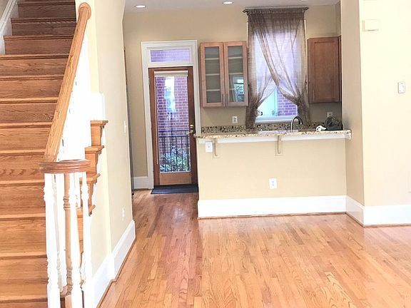 Full glass door leads to rear courtyard