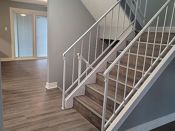 Hall to kitchen and upstairs 3 bedrooms, 2 bathrooms. Down to full basement, bedroom, living area, fireplace and laundry