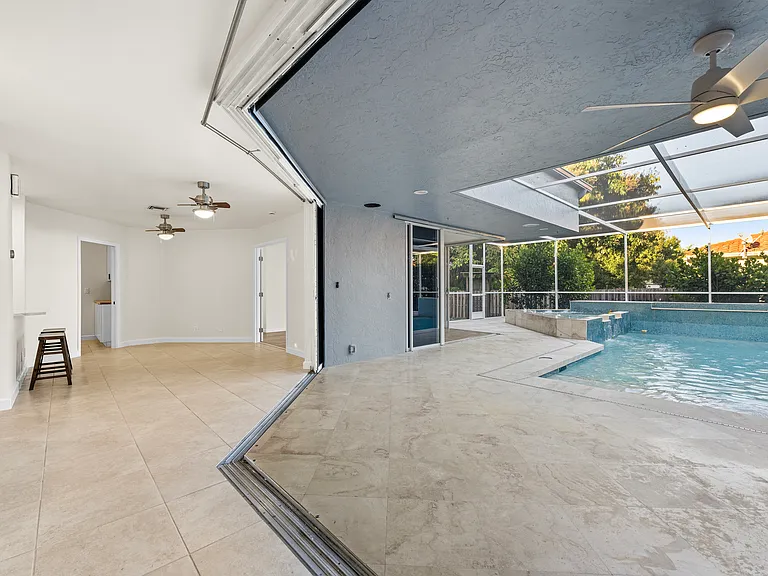 Rare courtyard design with direct pool access and views from throughout the home.