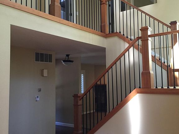 from kitchen, across entry toward family room and upstairs