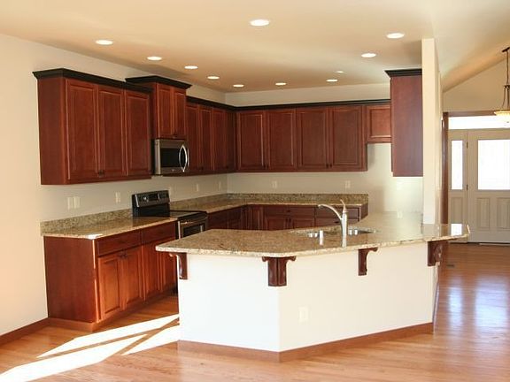 Generous & open kitchen with a eating bar with granite countertops & quality finishes